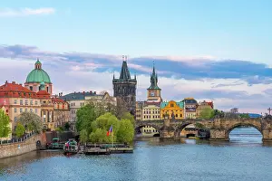 Charles Bridge and Church of Saint Francis of Assisi with Old Town Bridge Tower against sky at dusk, UNESCO World Heritage Site, Prague, Czech Republic (Czechia), Europe