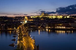 Charles Bridge over the River Vltava and Little Quarter illuminated at dusk, UNESCO World Heritage Site, Prague
