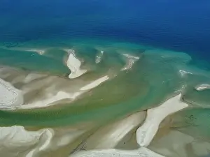 Madagascar Prints: Charter flight displays river flowing into sea near Antanavarino in Madagascar