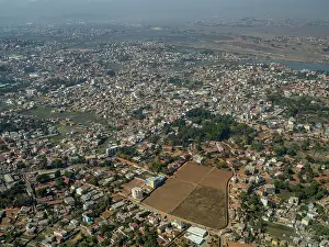 Province Prints: Charter flight travels over city from Isalo National Airport to Antanavarino Charter Flight Base in Madagascar