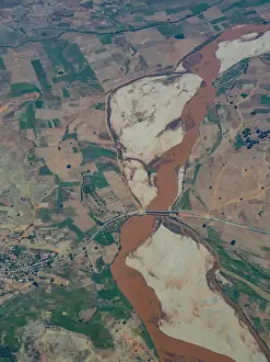 Uninhabited Prints: Charter flight view of a river flowing through the mountains in Madagascar near Anjajavy Private Reserve
