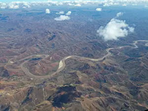 Madagascar Prints: Charter flight view of a river winding through mountains in Madagascar landscape