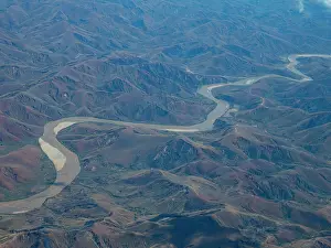 Ecology Prints: Charter flight view of a winding river through mountains in Madagascar