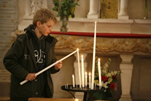 One Boy Only Prints: Child lighting a church candle, Toucy, Yonne, France, Europe