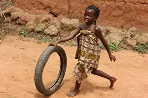 Benin Prints: Child playing with a tyre, Tori, Benin, West Africa, Africa