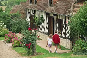 Calvados Prints: Children carrying baguettes in front of a typical half timbered cottage near St