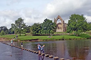 Images Dated 3rd January 2000: Children crossing the stepping stones across the river Wharfe at Bolton Abbey