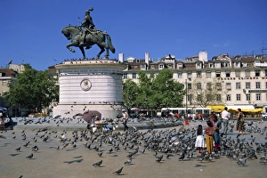 Pigeon Prints: Children feed pigeons in Figueira Square in Lisbon