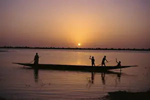 Children on local pirogue or canoe on the Bani River at sunset at Sofara, Mali, Africa