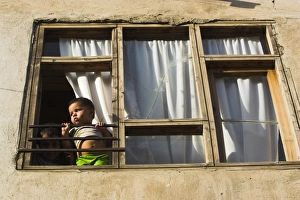 Child Prints: Children looking out of window of old house, Old City, Kabul, Afghanistan, Asia