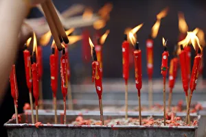 Chinese man burning incense and praying to a prosperous future Chinese man burning incense and praying to a prosperous future