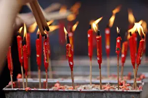 Human Hand Prints: Chinese man burning incense and praying to a prosperous future