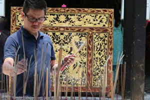 Incense Prints: A Chinese man praying and offering incense, Thian Hock Keng Temple, Singapore