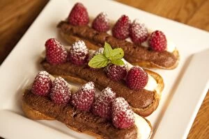 Images Dated 18th August 2010: Chocolate eclairs topped with raspberries, French cafe, France, Europe
