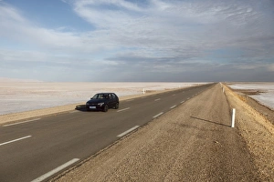 Salt Lake Prints: Chott El Jerid, a flat dry salt lake, and automobile on highway between Tozeur and Kebili