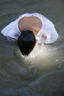 Pilgrims Prints: Christian pilgrim in Jordan River, Yardenit, Israel, Middle East