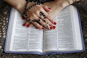 Touching Prints: Christian woman reading the Bible, Vietnam, Indochina, Southeast Asia, Asia