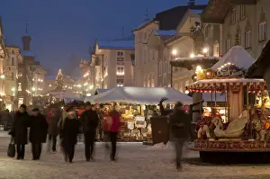 Stalls Prints: Christmas Market stalls and people at Marktstrasse at twilight