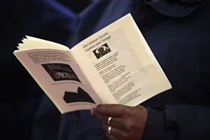 Reading Prints: Christmas service at Holy Trinity, Dalston, London, England, United Kingdom, Europe