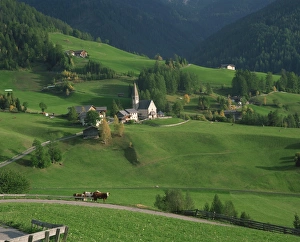 Church, houses and farmland in the Val di Funes in the Dolomites
