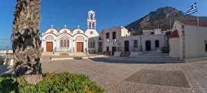 Metamorphosis Prints: Church of the Metamorphosis of the Savior stands in Piskopiano village in Crete under a clear sky with mountains