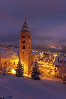 Snowflakes Prints: Church of Saint Pantalon and snow covered town centre and mountainous background in winter at dusk