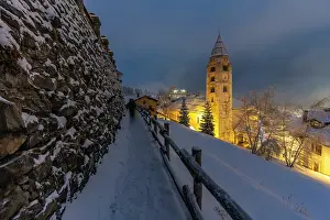 Snowflakes Prints: Church of Saint Pantalon and snow covered town centre and mountainous background in winter at dusk