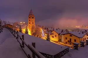Cozy Prints: Church of Saint Pantalon and snow covered town centre and mountainous background in winter at dusk