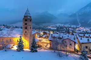 Centre Prints: Church of Saint Pantalon, snow covered town centre and mountainous background in winter at dusk