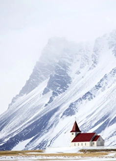 Snaefellsnes Peninsula Gallery: Church against snow covered mountains, winter afternoon, Snaefellsnes Peninsula, Iceland
