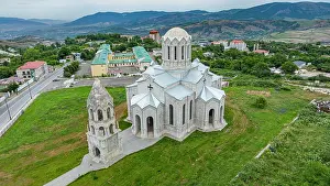 Overcast Prints: Church structure in Shuhsa surrounded by green landscape and buildings in Qarabaqh Azerbaijan