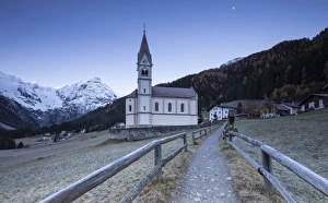 Church of Trafoi during frozen twilight with moon in the sky, Trafoi, Stelvio National Park