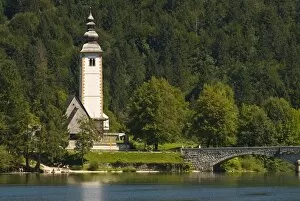 Church in village, bridge over Bohinj Lake, Slovenia, Europe