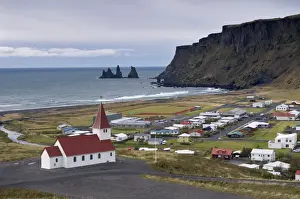 Church, village of Vik (Vik a Myrdal) and Reynisdrangar sea stacks in the distance