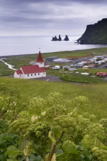 Sudurland Prints: Church and village of Vik (Vik a Myrdal) and Reynisdrangar sea stacks in the distance