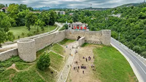 Gathering Prints: Citadel of Shusha with visitors and greenery surrounding the fortress in Qarabaqh