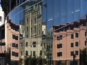Wellington Prints: City council buildings in Civic Square reflecting in glass wall of public library