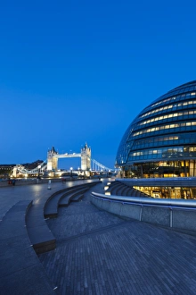 City Hall building, the home of the Greater London Authority, with Tower Bridge over the River Thames in the background, Borough of Southwark, London, England, United