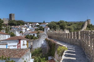 Stone Wall Prints: City overview with Wall and Medieval Castle in the background, Obidos, Portugal, Europe