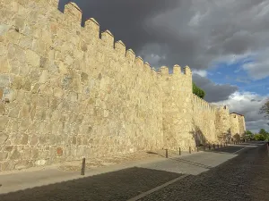 Cobblestone Prints: City walls showcase historic stone structure along street in Avila