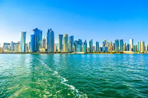 Qatar Prints: Cityscape of Doha West Bay skyline from boat trip in Doha Bay at sunset, Doha, Qatar