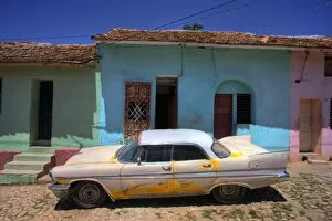 Images Dated 30th March 2009: Classic American car parked on cobbled street outside brightly painted houses