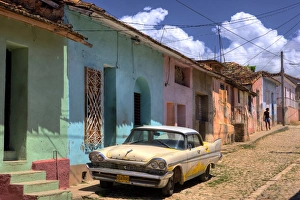 Images Dated 30th March 2009: Classic American car parked on cobbled street outside brightly painted houses