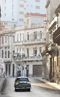 Cabs Prints: Classic American car taxi driving down quiet street in Havana Centro, Havana