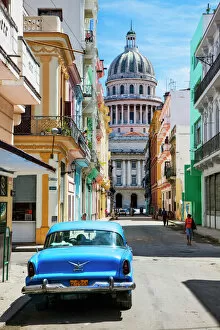Cuba Gallery: A classic car parked on the street next to colonial buildings with the former Parliament