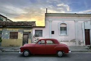 Cienfuegos Prints: Classic red American car parked outside houses at sunset, Cienfuegos, Cuba