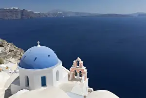 Greek Orthodox Prints: Classic view over the Caldera showing blue domed church and pink belltower, Oia, Santorini