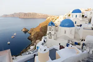 Classic view of the village of Oia with its blue domed churches and colourful houses