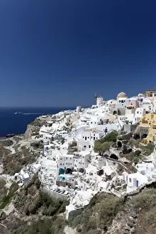 Classic view of the village of Oia with its windmill and whitewashed houses, Oia