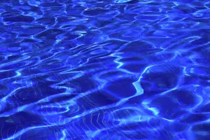 Spot Prints: Clear blue water waves form patterns in the pool at a resort in Seychelles under the bright sun